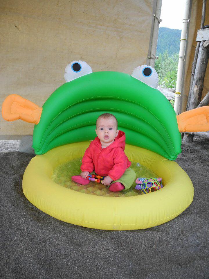 baby sitting in inflatable pool for camping