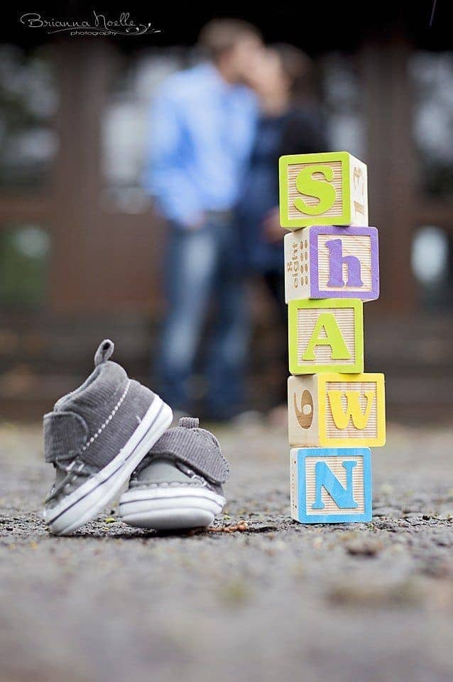 block spelling baby name with baby shoe props