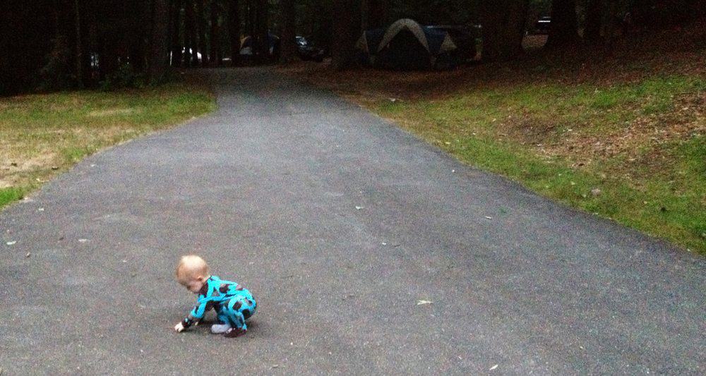 baby in pajamas at campsite