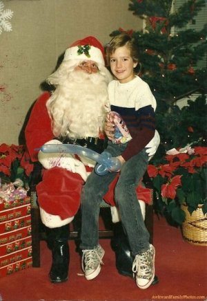 funny balloon sword with boy sitting on santa's lap