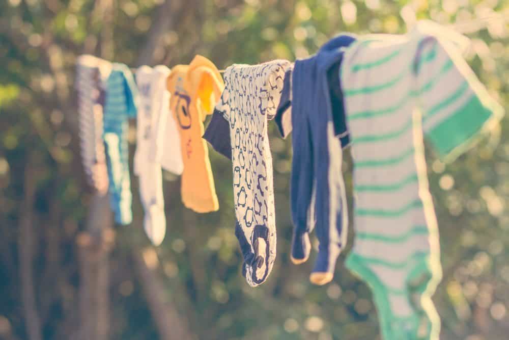 baby clothes hanging in the sun on a line