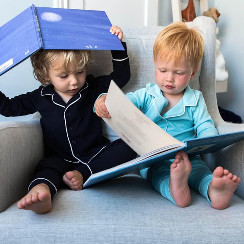 toddlers reading books from subscription service