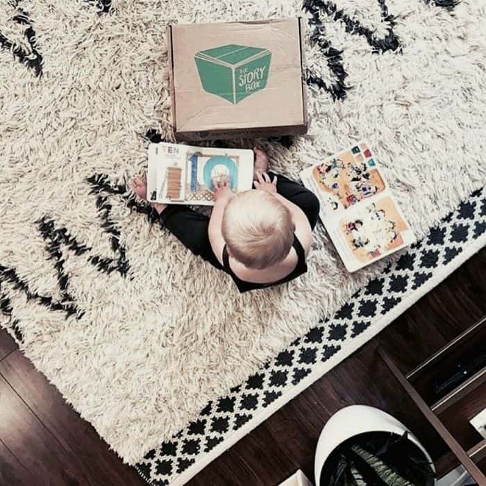 baby reading book from baby subscription box
