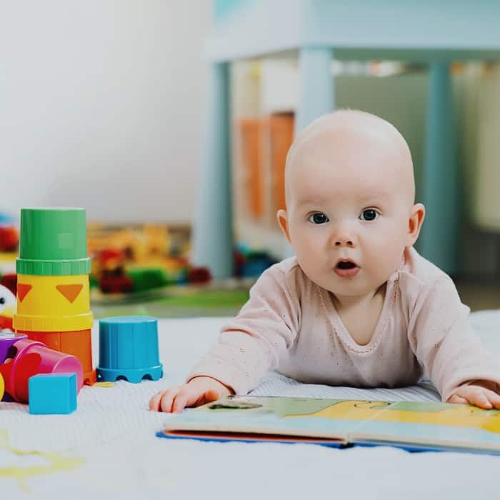 baby with book during tummy time