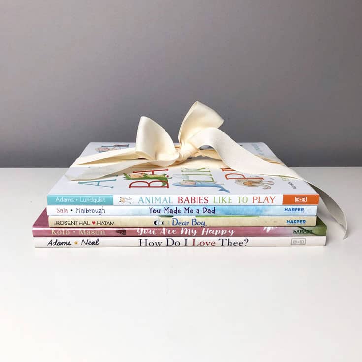 stack of baby books with a bow