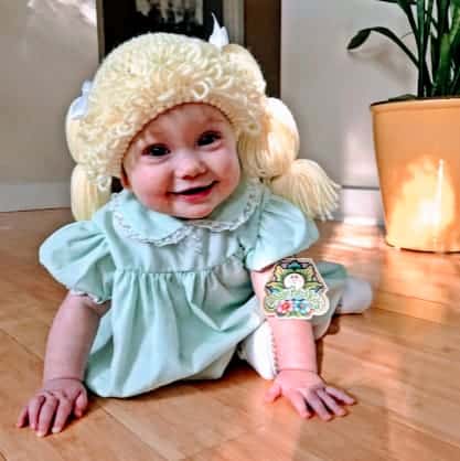 baby dressed as cabbage patch doll