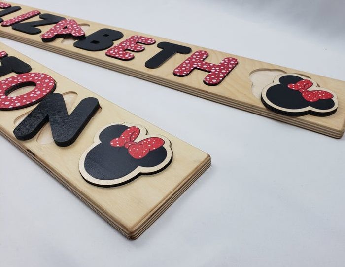 3D name puzzles with black and red letters, and a Minnie Mouse piece.