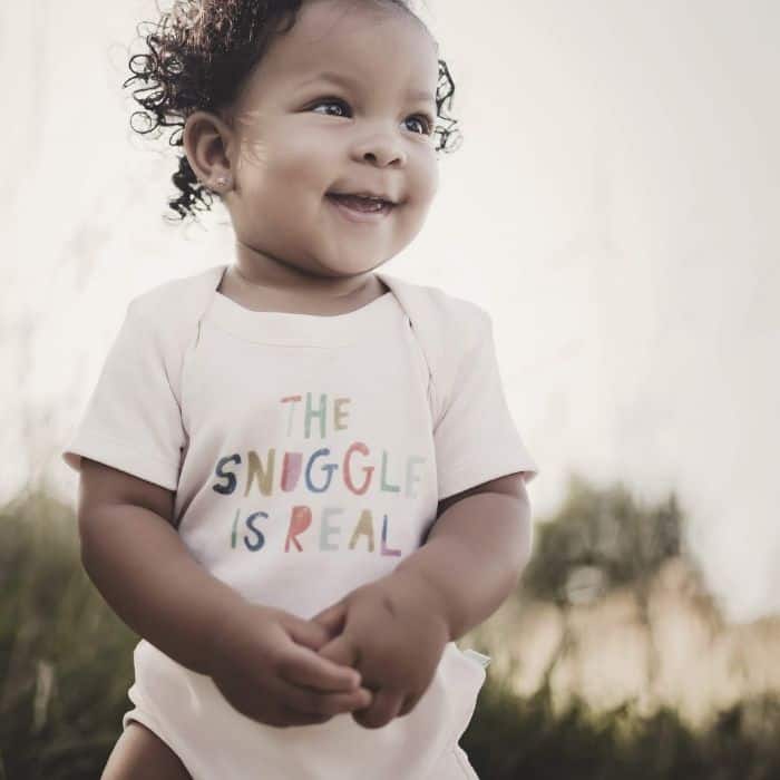 toddler wearing a 'the snuggle is real' onesie