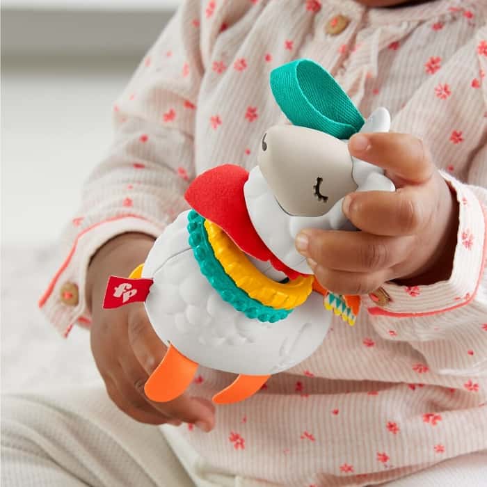baby playing with Fisher Price Click Clack llama