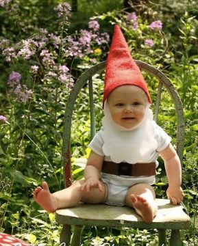 baby outside dressed as gnome
