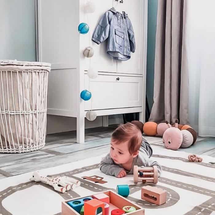 baby playing on the floor with toys from baby subscription box