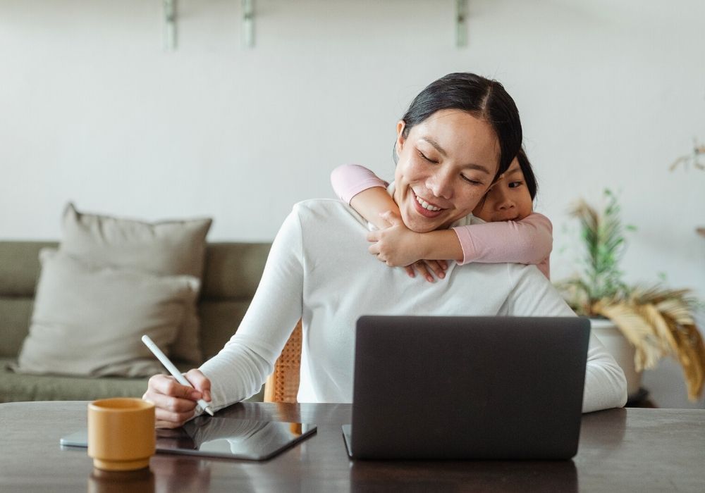 daughter with her mom working as a translator for her stay at home job