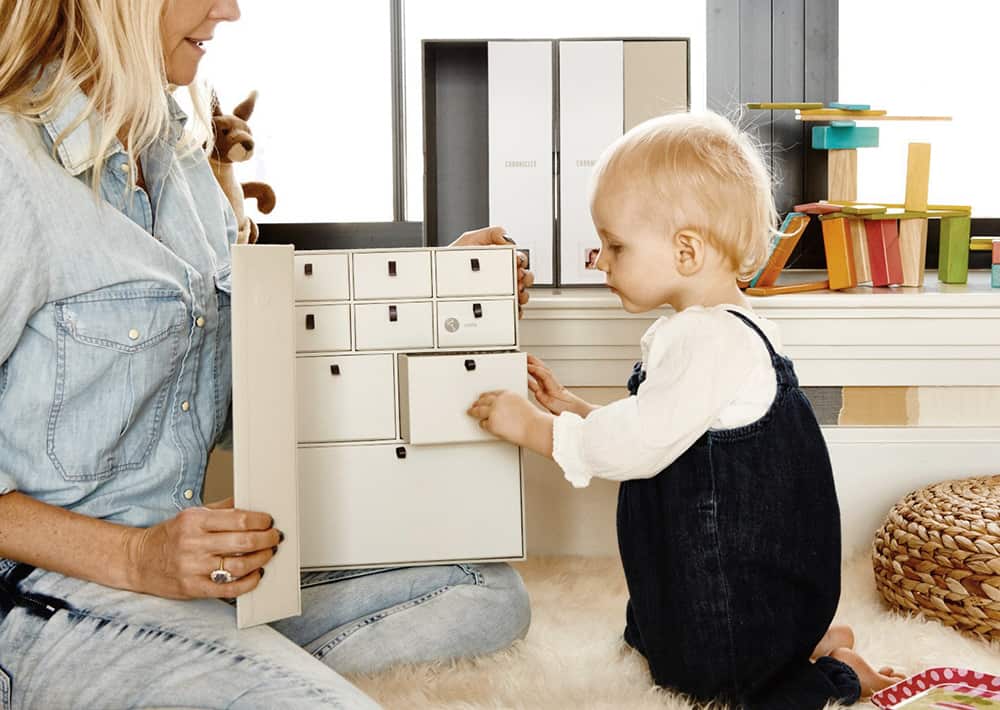 mom and baby putting items in memory box