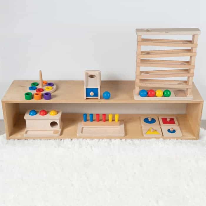 Montessori play room with a low shelf with wooden toys