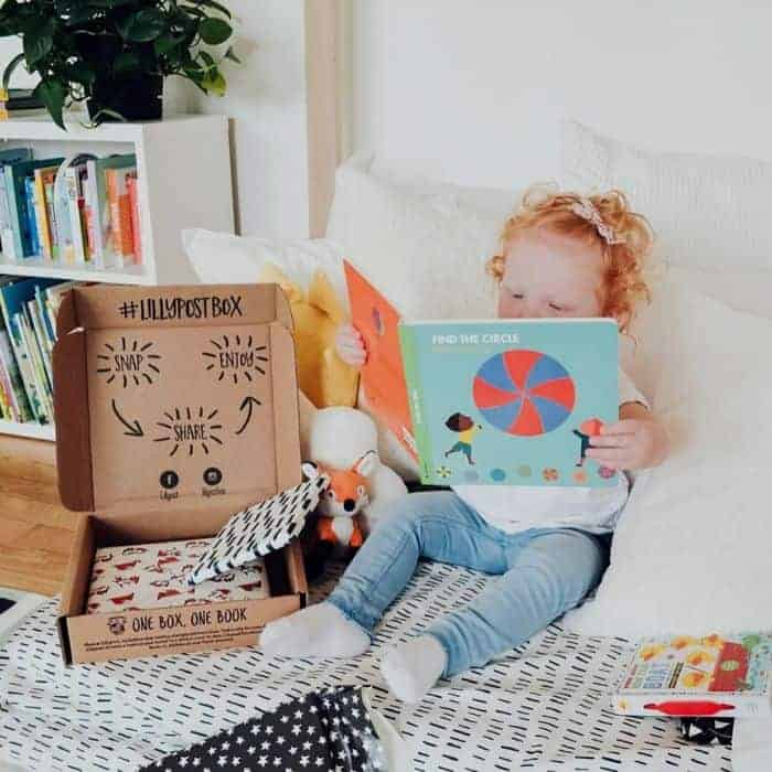 Kid reading book from baby subscription box