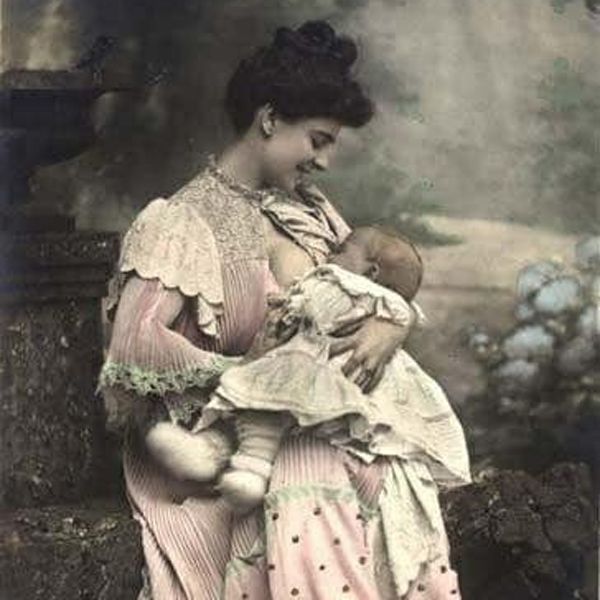 Old breastfeeding image of Victorian era mother nursing baby in a park