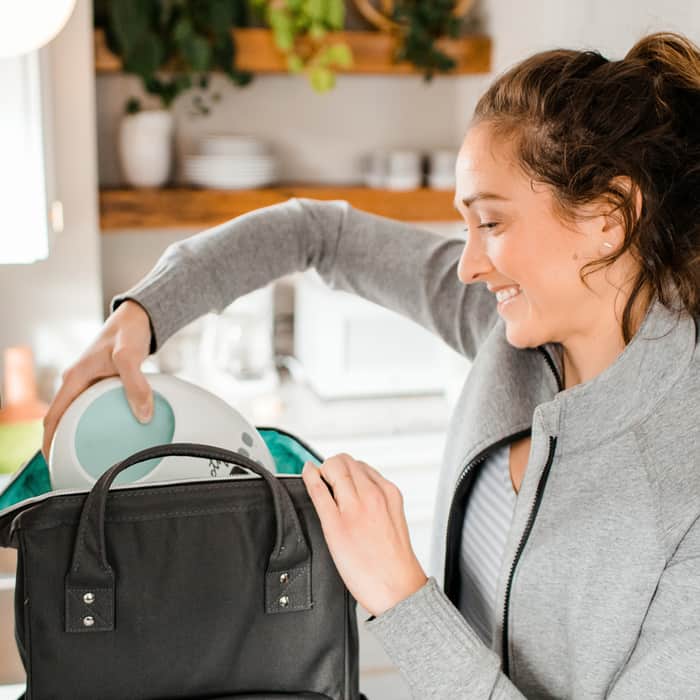 mom unpacking breast pump from bag