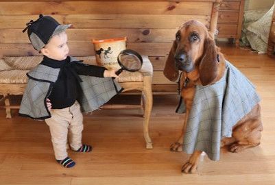 baby dressed as sherlock holmes with bloodhound