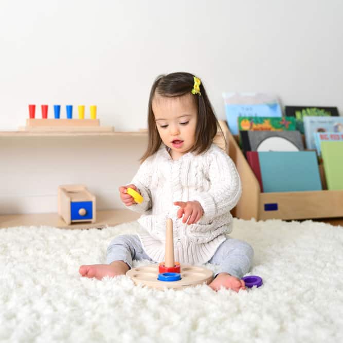 toddler playing with wooden toys