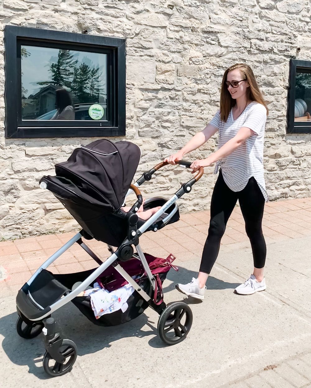 Mom walking with her baby in a stroller