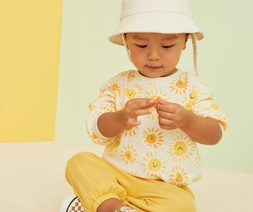 baby in yellow outfit from old navy with suns on the the shirts