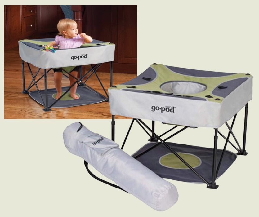 baby sitting in a portable foldup activity seat