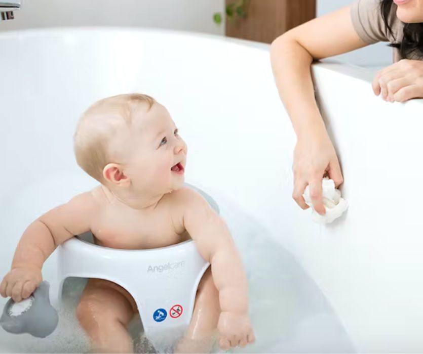 baby in tub sitting in bath chair