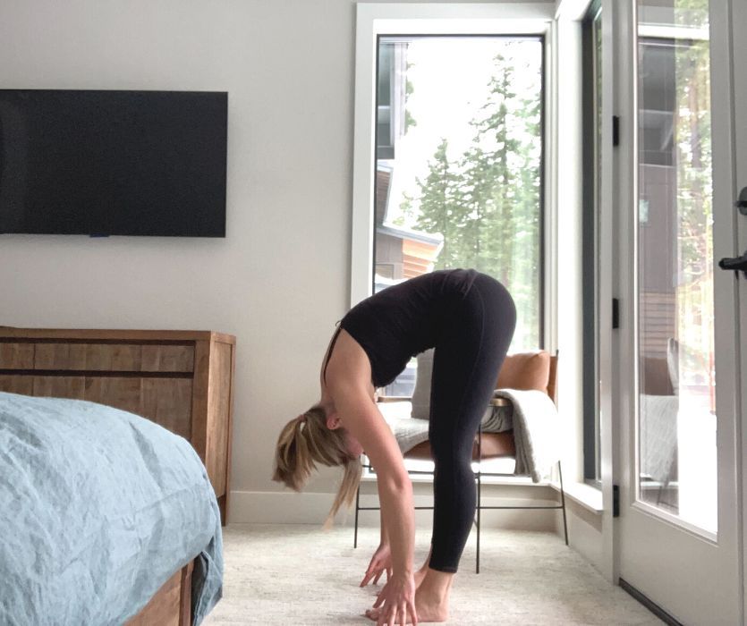 Female doing forward fold yoga pose
