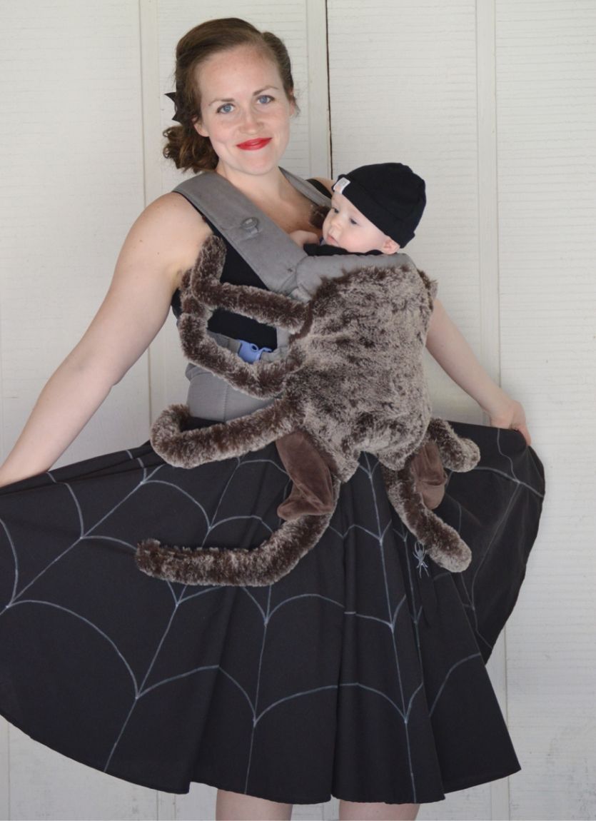 mom and baby in a carrier dressed as a spider in a spider web
