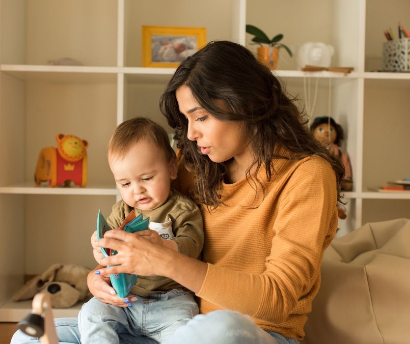 babysitter reading a book to a baby