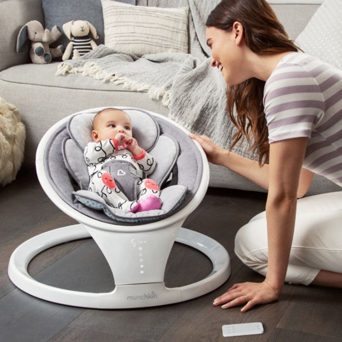 mom looking at baby in a swing