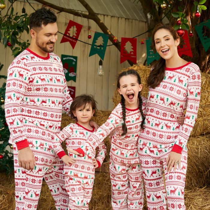 family of four wearing reindeer holiday pjs