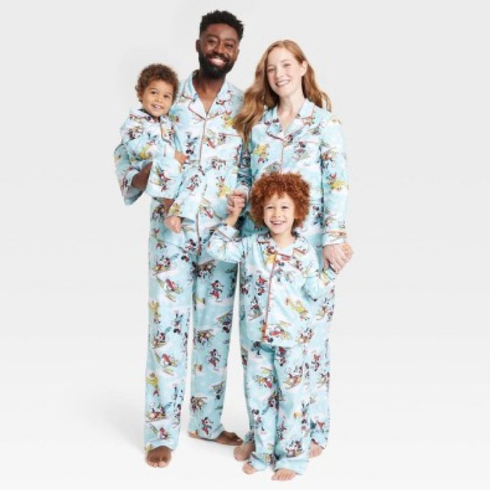 family wearing matching disney pajamas