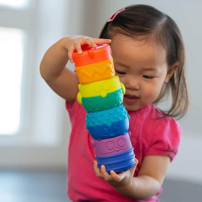 toddler playing with sassy baby toy