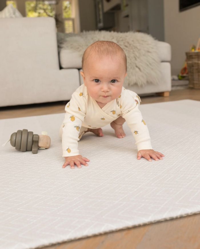 baby crawling on a totter + tumble playmat